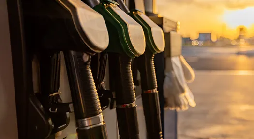 Closeup of gas pumps with the sun shining in the distance