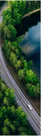 Car driving alongside a lake